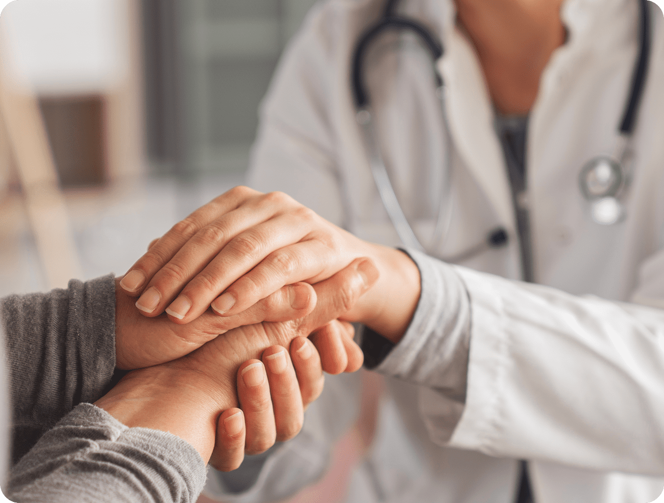 Doctor comforting patient with hand touch