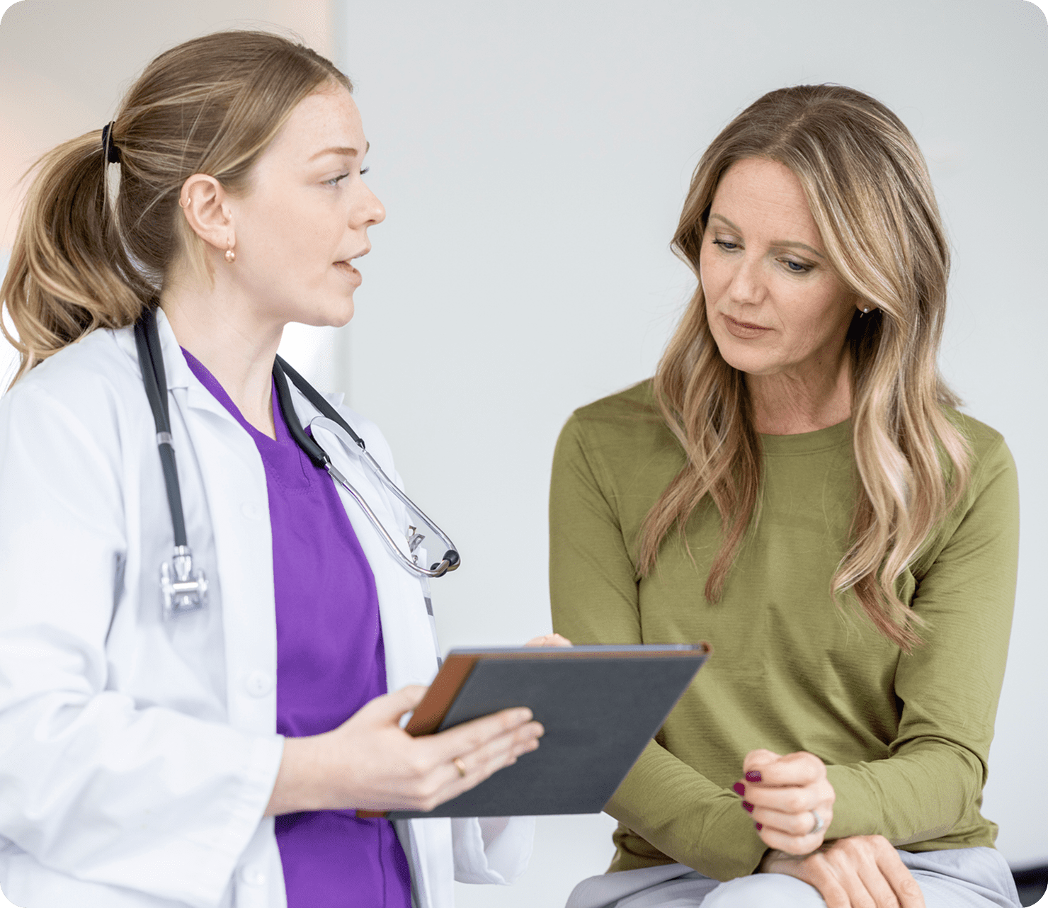 Medical consultation with tablet discussion.